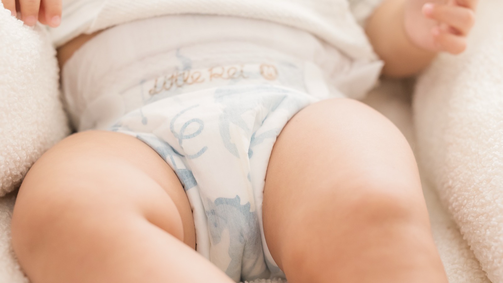 A baby lying in a Little Rei tape diaper