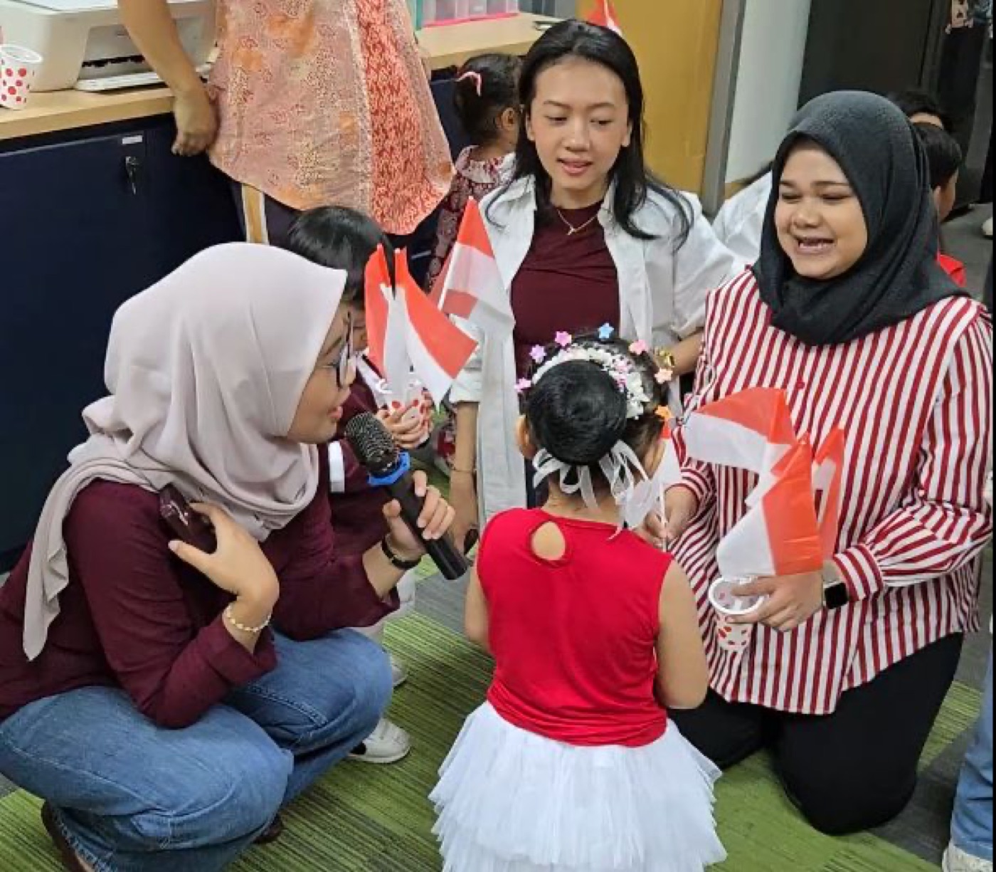 Team members with children at the Independence Day celebration