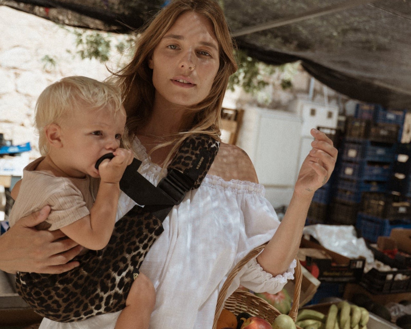 A mum carrying her toddler in a WildRide carrier